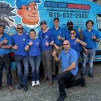 home service franchise owners in front of a van