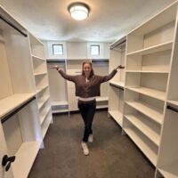 Up Closets franchise owner standing in a closet she created for a client